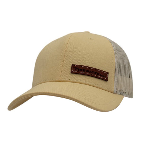 Light yellow and beige cap with a mesh back and a brown leather patch containing the tidewater logo on the left front side.