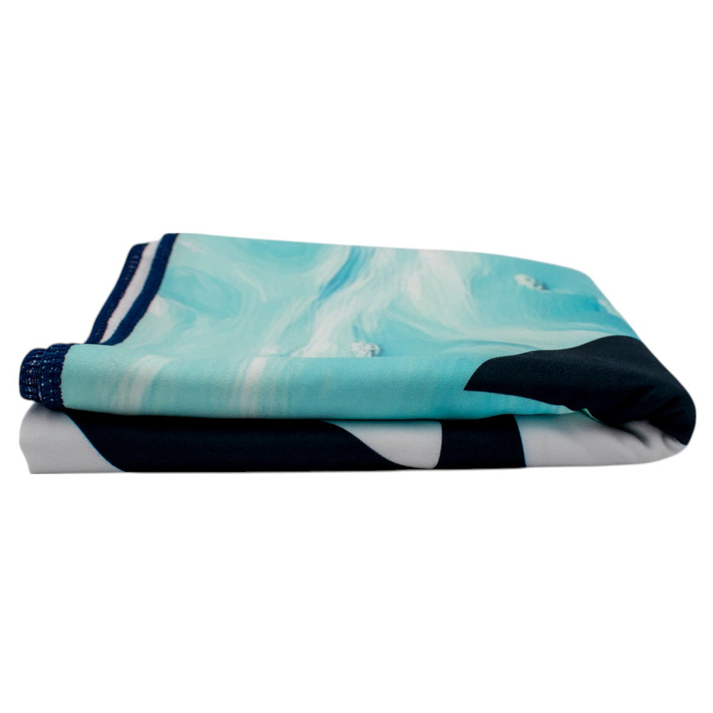 A thin, folded microfiber beach towel with blue and white pattern.