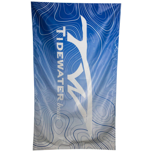A blue and white flag featuring the Tidewater logo and a topographical design.