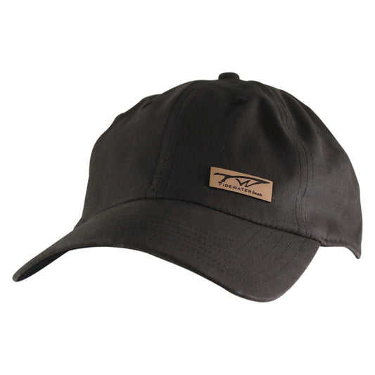 A dark brown baseball cap with a small tidewater leather logo patch on the left front panel.