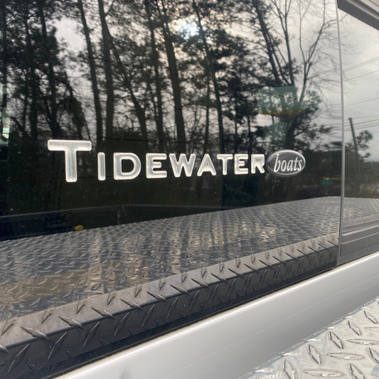 Clear Tidewater Boats decal on the back window of a truck.