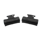 Two black plastic steering clips on a white background