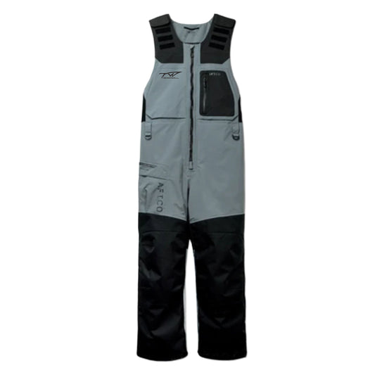 A pair of grey and black fishing bibs with padded straps, a front zipper, pockets, and a small tidewater logo on the right chest.